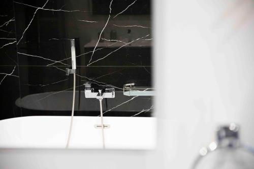 a bathroom with a sink with a broken mirror at Flat 2, stay close to Countryside & Beaches in Mġarr