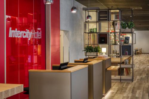 a restaurant with wooden counters and red walls at IntercityHotel Wiesbaden in Wiesbaden