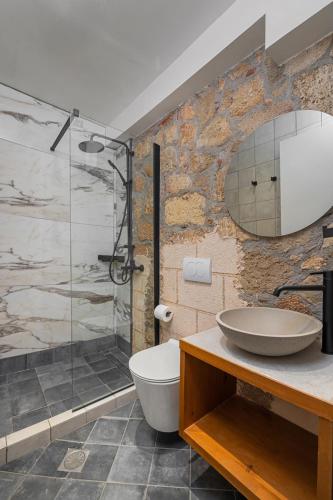 a bathroom with a sink and a glass shower at Casa del Sol Suites in Rhodes Town