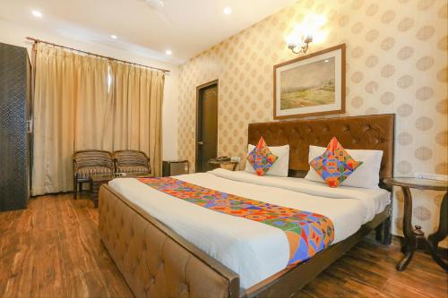 a bedroom with a large bed in a room at FabHotel Pulse Impulse in New Delhi
