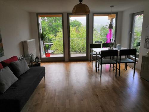 a living room with a couch and a table with chairs at Apartment Sonnenschein in Bühl