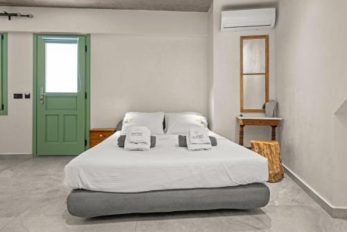 a bedroom with a bed with a green door at Casa del Sol Suites in Rhodes Town
