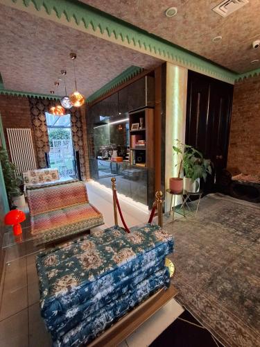 a living room with a couch and a table at The Melville Hotel by Rokxy- Kings Cross in London