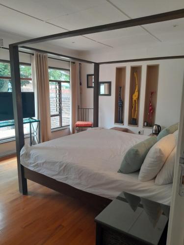 a bedroom with a large bed in a room at Palm Estate in Edenvale