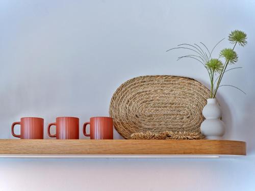 a shelf with cups and a vase on it at Casa Stellino in Kampos Paros