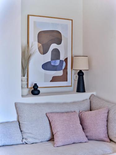 a living room with a couch and a painting at Casa Stellino in Kampos Paros