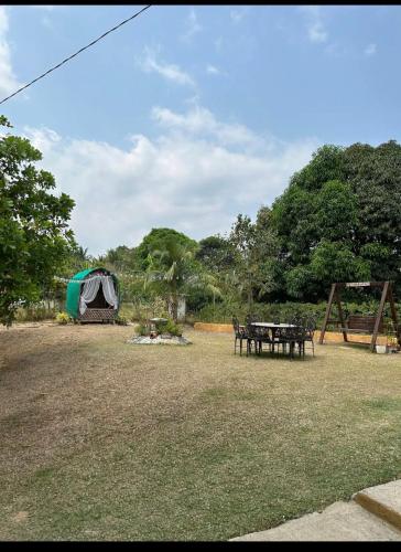 a tent and a picnic table in a field at KEHLANI Vacation Farmhouse in Hermosa