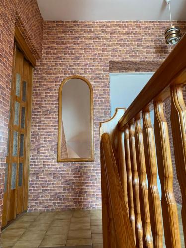 a hallway with a brick wall and a mirror at Willa Malwa in Rewal