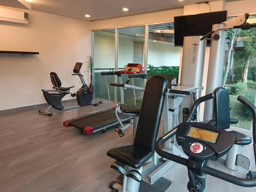 a gym with several exercise equipment in a room at La Foresta Khaoyai in Pak Chong