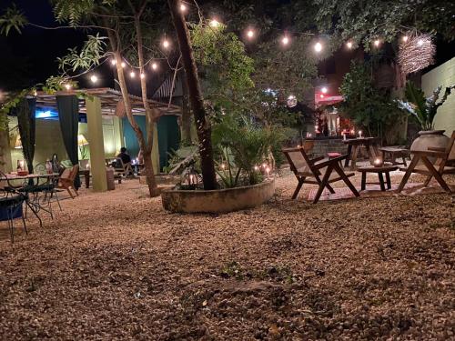 a patio with tables and chairs at night with lights at Casa Sílice Guesthouse in Valladolid