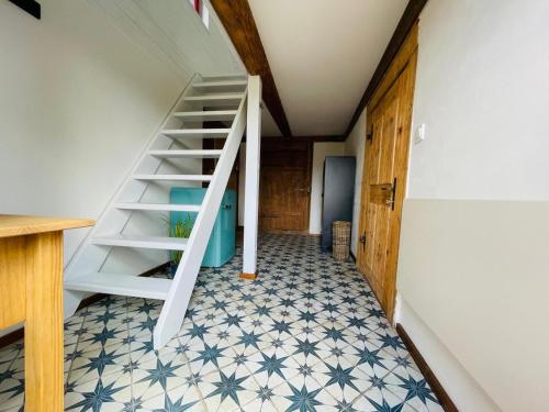 a staircase in a room with a tiled floor at Chata Vlčanda 346 in Staré Křečany