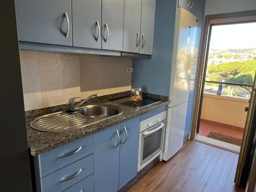 a kitchen with a sink and a counter top at Calypso Holidays in Sitio de Calahonda