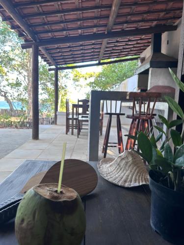 a coconut sitting on top of a wooden table at Manay Lagoa do Paraíso, casa 2 quartos na beira da Lagoa in Jijoca de Jericoacoara