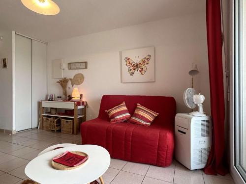 un salon avec un canapé rouge et une table dans l'établissement Appart Studio cabine 4 couchages BANYULS SUR MER BN120-3007, à Banyuls-sur-Mer