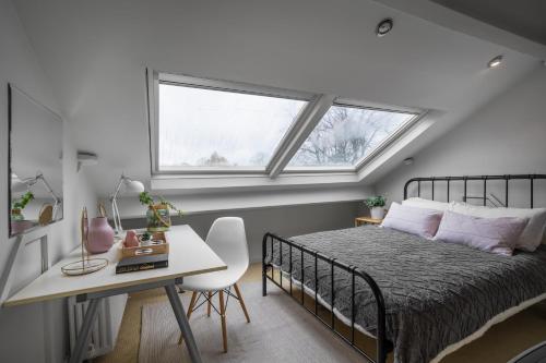 a bedroom with a bed and a desk and a window at Norfolk House Hosted by The Scarlet Hen in Huddersfield