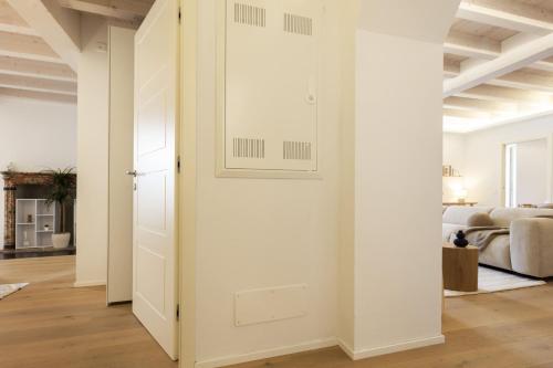 an open door in a white room with a bedroom at Luxury flat by the lake in Morcote
