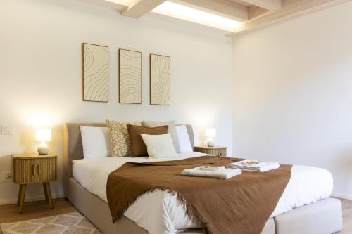 a bedroom with a large bed with a brown blanket at Luxury flat by the lake in Morcote
