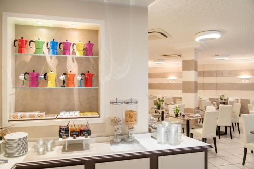 a restaurant with colorful vases on the wall at All'Orologio - Boutique Hotel in Caorle