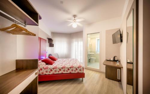 a hotel room with a bed and a bathroom at All'Orologio - Boutique Hotel in Caorle