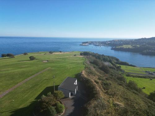 an aerial view of a golf course next to the water at Dunmore East Ocean View Suite in Dunmore East