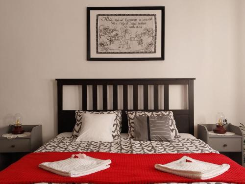 a bedroom with a bed with two towels on it at Lankás Vendégház - Hollókő in Hollókő