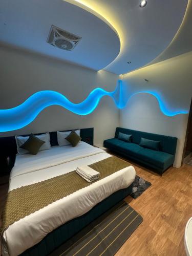 a bedroom with a bed and a couch in it at Hotel victoria prime in Surat