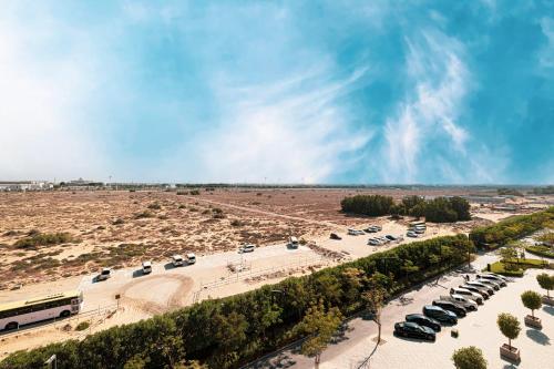 an aerial view of a parking lot with cars at 1BR The Modern Al Jada Home by Blue Cloud Holidays in Sharjah