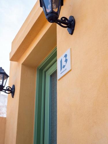 a sign on the side of a building with a window at Casa del Sol Suites in Rhodes Town