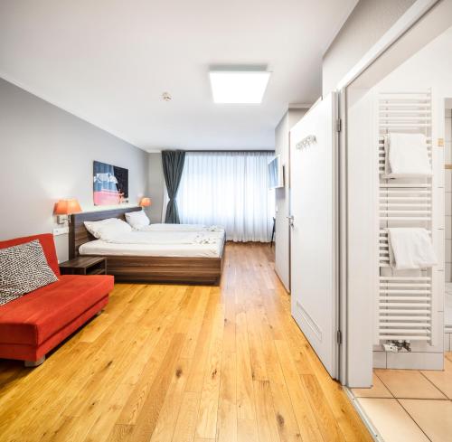 a bedroom with a bed and a couch at BoardingWorld Heidelberg in Heidelberg