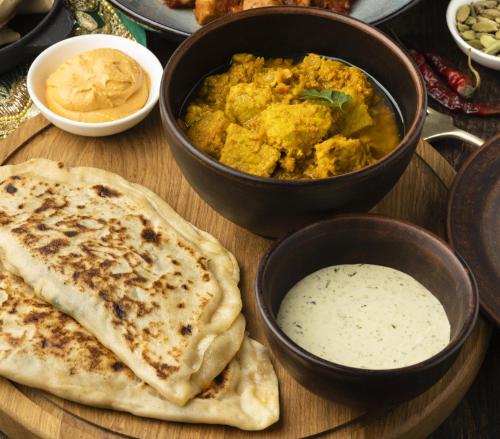 a wooden table topped with bowls of food and dip at My Vacation Inn Rooms in kodaikanal in Kodaikānāl