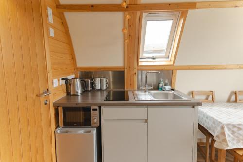 a small kitchen with a sink and a microwave at Ribble Valley by Wigwam Holidays in Langho