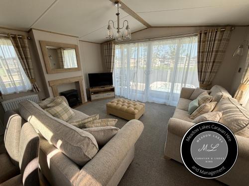 a living room with two couches and a tv at The Retreat 39 - Hot tub Mini Lodge - Golden Palm - pet friendly, WiFi, central heating, bed linen - Meadow Lakes Caravan & Lodge Hire in Chapel Saint Leonards