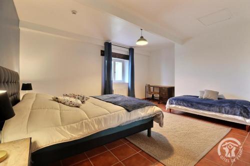 a bedroom with two beds and a window at La ville lesne 2 in Montauban-de-Bretagne