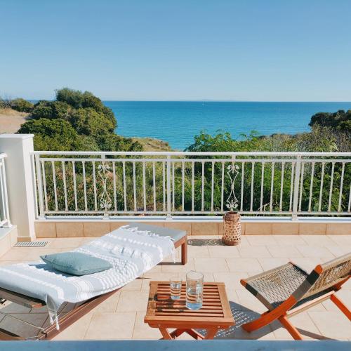 a patio with a couch and a table and chairs at KALAMIES - Secluded Beach Apartments in Skala