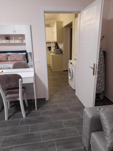 a room with a table and a bed and a kitchen at Azure Sands Golem in Golem