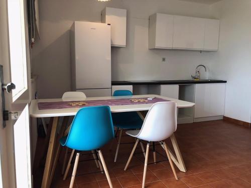 a kitchen with a table and four chairs at Apartments Seaview in Podaca