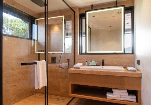 a bathroom with a sink and a shower at Brightland Resort & Spa in Mahabaleshwar