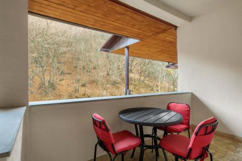 a room with a table and chairs and a window at Apricot Aghveran Resort in Agveran