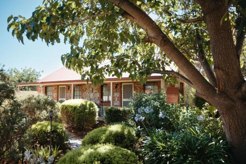 a house with a garden in front of it at Langmeil Cottages in Tanunda