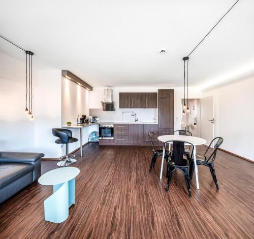 a living room with a couch and a table and chairs at BoardingWorld Heidelberg in Heidelberg