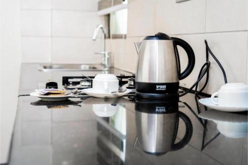 a coffee maker on a counter in a kitchen at Hemak Suites Hotel in Nairobi