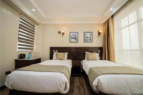 Postel nebo postele na pokoji v ubytování Hemak Suites Hotel