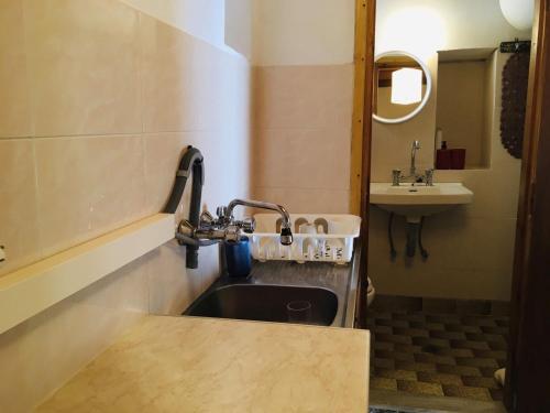 a sink in a small bathroom with a sink at Beliotis' House in Apérathos