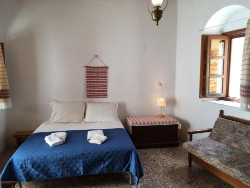 a bedroom with a bed with two towels on it at Beliotis' House in Apérathos