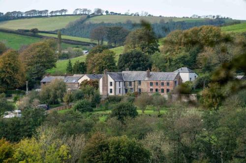 a large house in the middle of a field at The West Wing in Barnstaple
