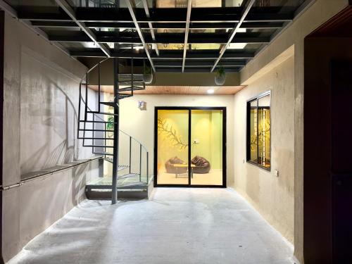 a hallway with a glass door in a building at Villa Vista - 3BHK Penthouse in Indore