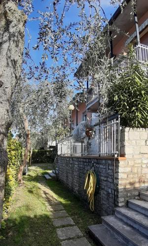 a house with a fence and some stairs at Villa sul Lago con pontile privato a Brenzone sul Garda - Unique and exclusive in Brenzone sul Garda