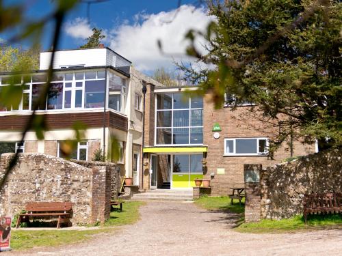 an external view of a building with a stone wall at YHA Truleigh Hill in Shoreham-by-Sea