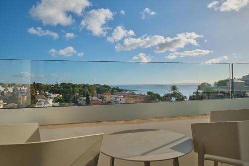 a balcony with a view of the ocean at Hotel Son Caliu Spa Oasis in Palmanova