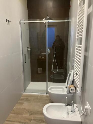 a bathroom with a shower and a toilet and a sink at Archè Agriturismo in Gioia del Colle